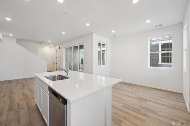 kitchen with sink, light hardwood / wood-style flooring, a center island with sink, dishwasher, and white cabinets
