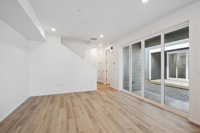 spare room featuring light wood-type flooring