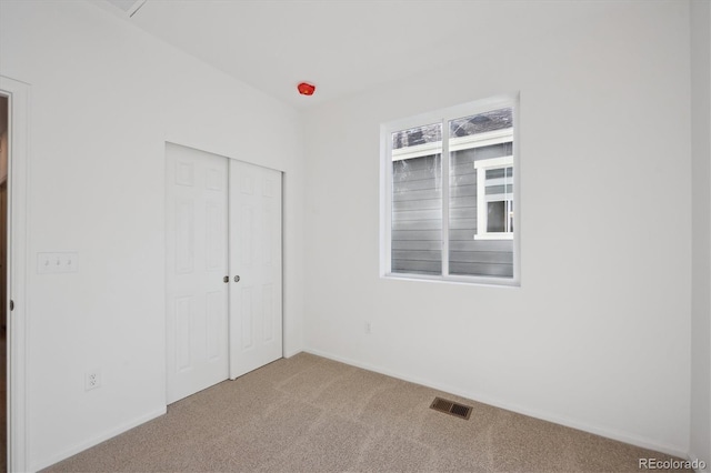unfurnished bedroom with a closet and carpet