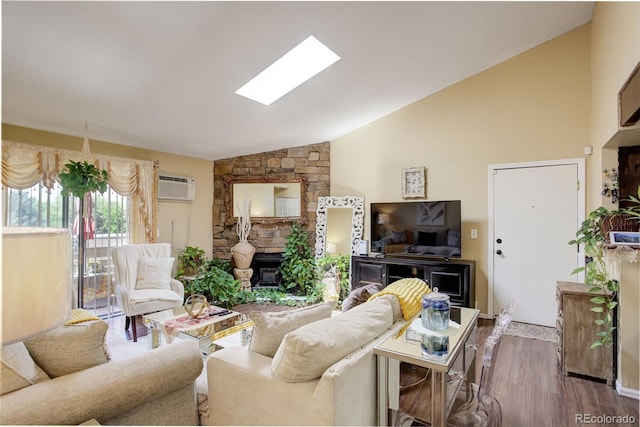 10150 E Virginia Ave Unit 18-302, Denver, CO 80247 - living room with a fireplace, a wall unit AC, wood finished floors, a skylight, and high vaulted ceiling