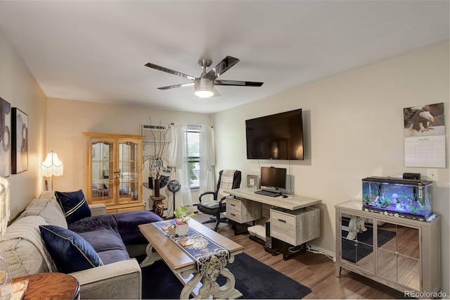 10150 E Virginia Ave Unit 18-302, Denver, CO 80247 - living room with wood finished floors, a ceiling fan, an office area, and baseboard heating