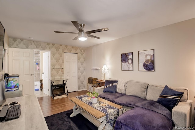 10150 E Virginia Ave Unit 18-302, Denver, CO 80247 - living room featuring wallpapered walls, dark wood finished floors, a ceiling fan, and baseboards