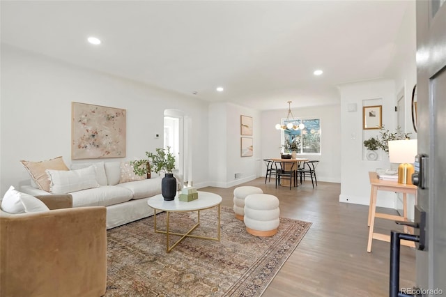 211 Newport St, Denver, CO 80220 - living area with arched walkways, wood finished floors, recessed lighting, baseboards, and a chandelier