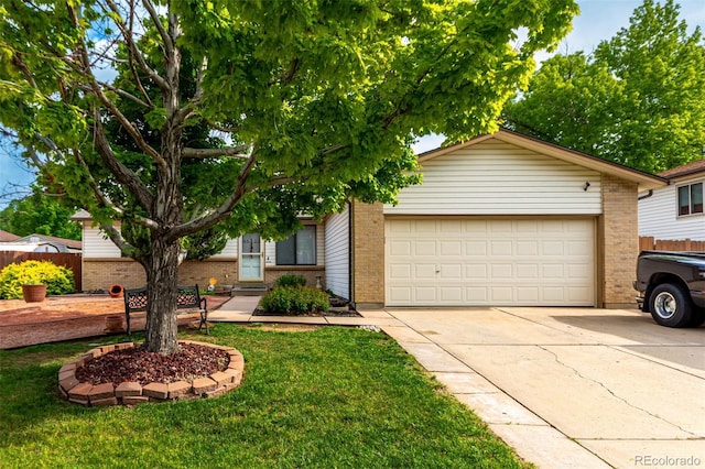 4520 E 112th Pl, Thornton, CO 80233 - view of front of home with brick siding, driveway, an attached garage, and a front yard