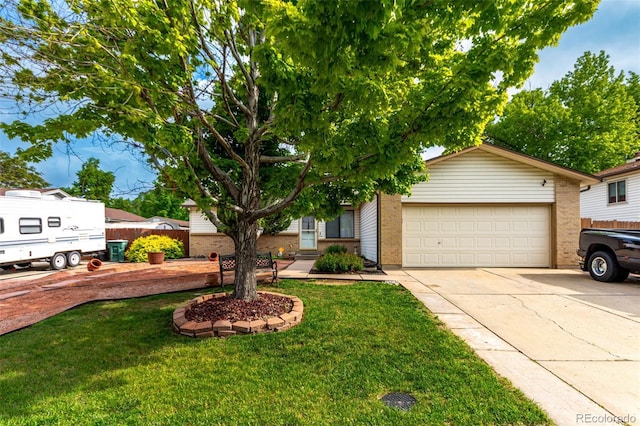 4520 E 112th Pl, Thornton, CO 80233 - view of front of home featuring driveway, brick siding, a front yard, and an attached garage