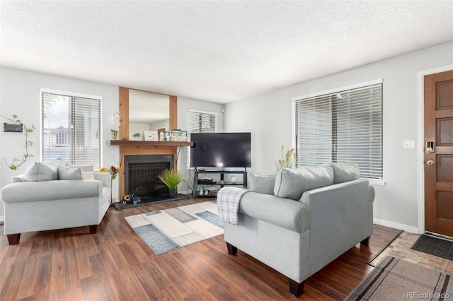4520 E 112th Pl, Thornton, CO 80233 - living area featuring wood finished floors, a fireplace, a textured ceiling, and baseboards