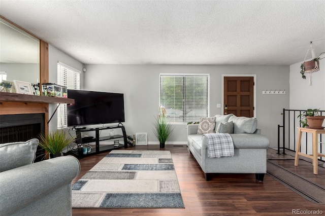4520 E 112th Pl, Thornton, CO 80233 - living area with healthy amount of natural light, a textured ceiling, dark wood-style floors, and a fireplace