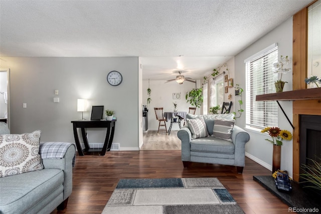 4520 E 112th Pl, Thornton, CO 80233 - living area featuring wood finished floors, a textured ceiling, ceiling fan, and baseboards