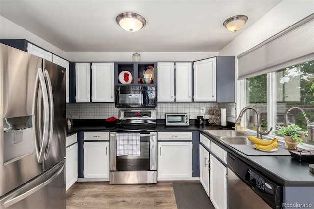 4520 E 112th Pl, Thornton, CO 80233 - kitchen with appliances with stainless steel finishes, a sink, dark countertops, and tasteful backsplash
