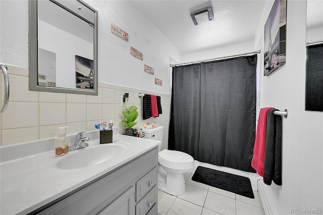 bathroom featuring walk in shower, toilet, tile walls, vanity, and tile patterned flooring