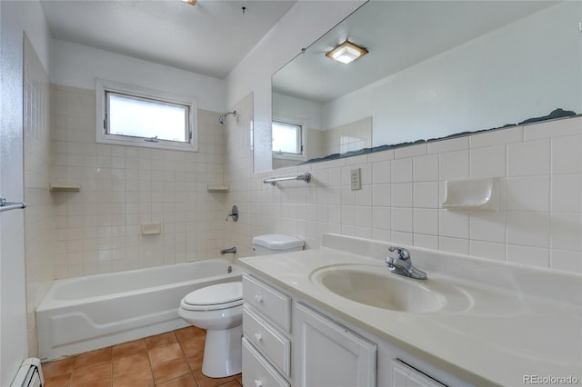 full bathroom with tiled shower / bath, plenty of natural light, tile walls, and a baseboard heating unit