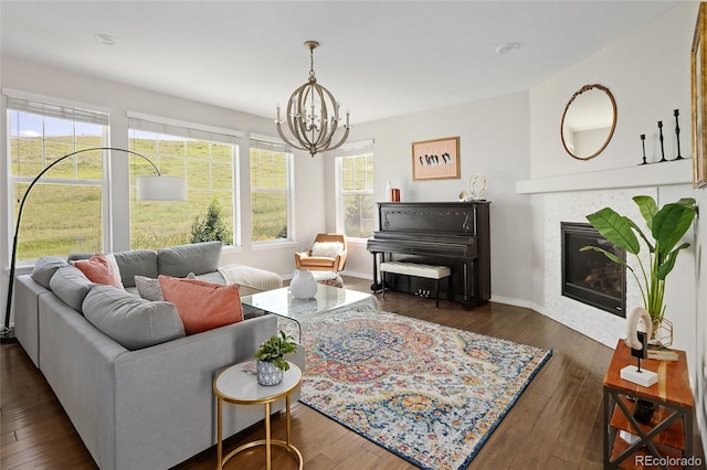 18992 W 84th Ave, Arvada, CO 80007 - living room with a chandelier, a fireplace, and wood-type flooring