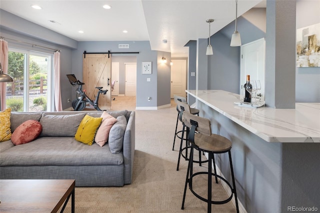 18992 W 84th Ave, Arvada, CO 80007 - living room featuring a barn door, light colored carpet, and recessed lighting