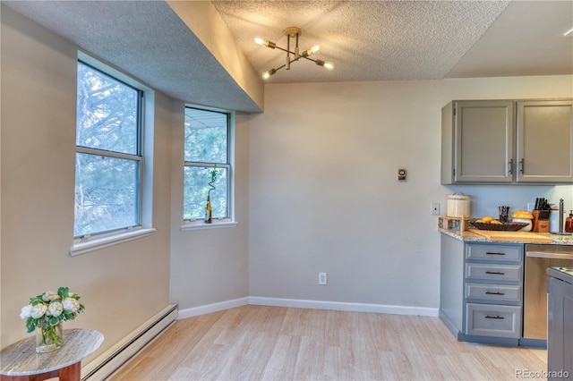 17595 E Mansfield Ave Unit 1331L, Aurora, CO 80013 - kitchen featuring gray cabinets, baseboard heating, light wood-style floors, a textured ceiling, and baseboards