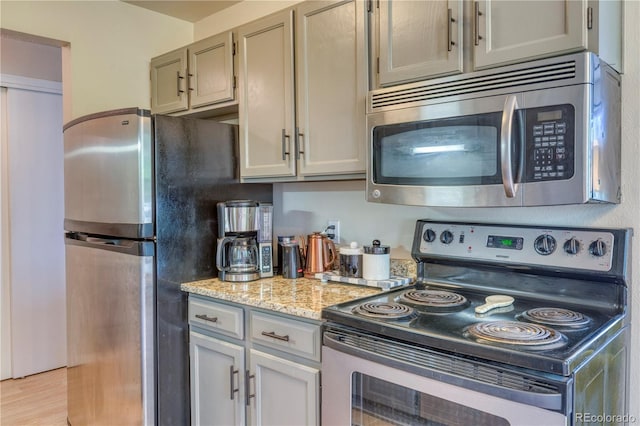 17595 E Mansfield Ave Unit 1331L, Aurora, CO 80013 - kitchen featuring appliances with stainless steel finishes and light stone counters
