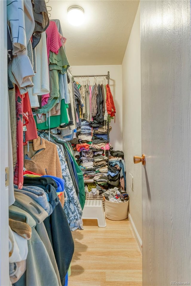 17595 E Mansfield Ave Unit 1331L, Aurora, CO 80013 - walk in closet featuring wood finished floors