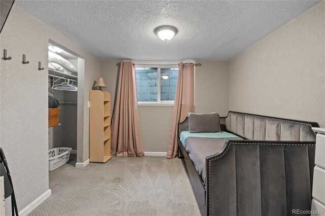 3625 Chase St, Wheat Ridge, CO 80212 - carpeted bedroom featuring a textured ceiling, baseboards, and a textured wall