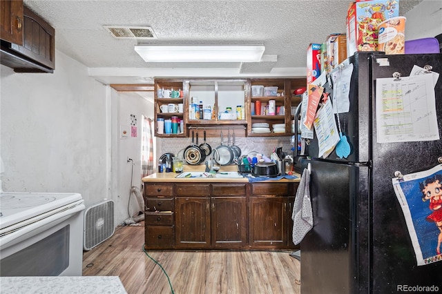 3625 Chase St, Wheat Ridge, CO 80212 - kitchen with freestanding refrigerator, white electric stove, a textured ceiling, light wood-style flooring, and dark brown cabinetry