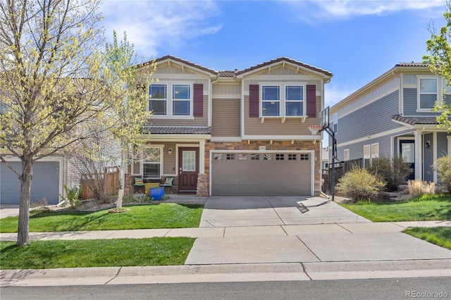 craftsman-style home with a garage, a front yard, stone siding, a tiled roof, and concrete driveway