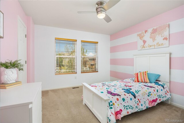 bedroom featuring baseboards, light carpet, and ceiling fan