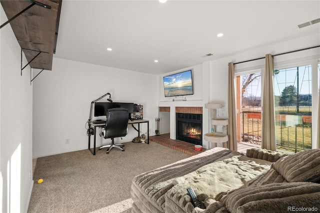 bedroom with visible vents, access to outside, carpet, a brick fireplace, and recessed lighting