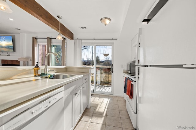 kitchen featuring light tile patterned floors, white appliances, a sink, white cabinetry, and light countertops