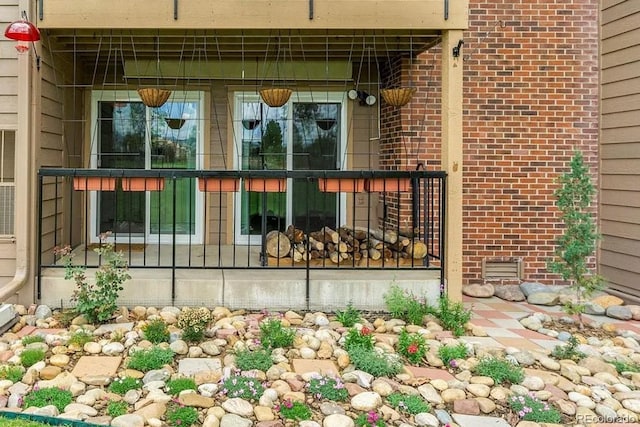 property entrance with crawl space and brick siding