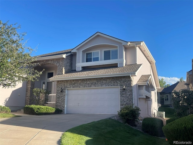 588 Stafford Cir, Castle Rock, CO 80104 - view of front of home with driveway, stone siding, a garage, and a shingled roof