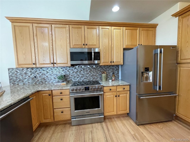 588 Stafford Cir, Castle Rock, CO 80104 - kitchen with stainless steel appliances, light wood finished floors, light stone counters, backsplash, and recessed lighting