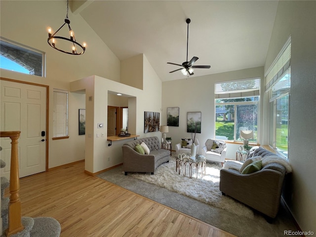 588 Stafford Cir, Castle Rock, CO 80104 - living room with high vaulted ceiling, light wood-style floors, a chandelier, and a ceiling fan