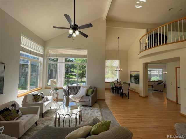 588 Stafford Cir, Castle Rock, CO 80104 - living room with high vaulted ceiling, wood finished floors, ceiling fan, a chandelier, and beamed ceiling