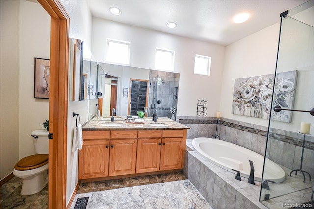 588 Stafford Cir, Castle Rock, CO 80104 - bathroom with a bath, double vanity, a tile shower, stone finish floors, and recessed lighting