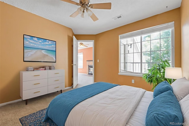 13782 E Lehigh Ave Unit H, Aurora, CO 80014 - bedroom featuring light colored carpet and a ceiling fan