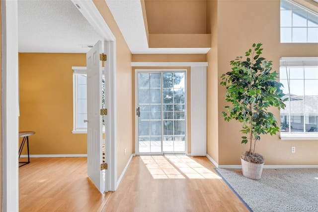13782 E Lehigh Ave Unit H, Aurora, CO 80014 - entryway featuring wood finished floors and healthy amount of natural light