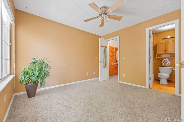 13782 E Lehigh Ave Unit H, Aurora, CO 80014 - unfurnished bedroom with carpet floors, ensuite bathroom, a textured ceiling, a spacious closet, and ceiling fan