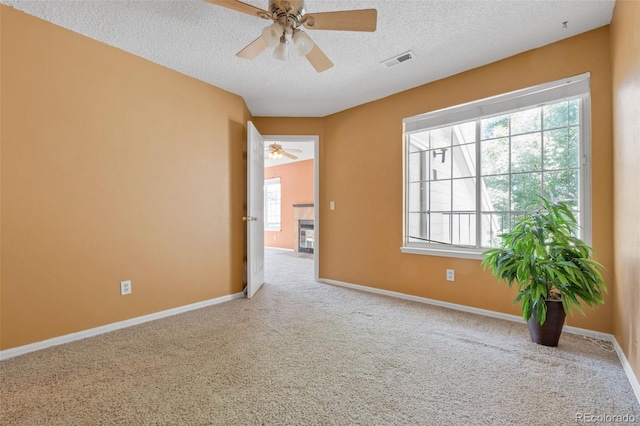 13782 E Lehigh Ave Unit H, Aurora, CO 80014 - carpeted spare room with ceiling fan, a textured ceiling, and healthy amount of natural light