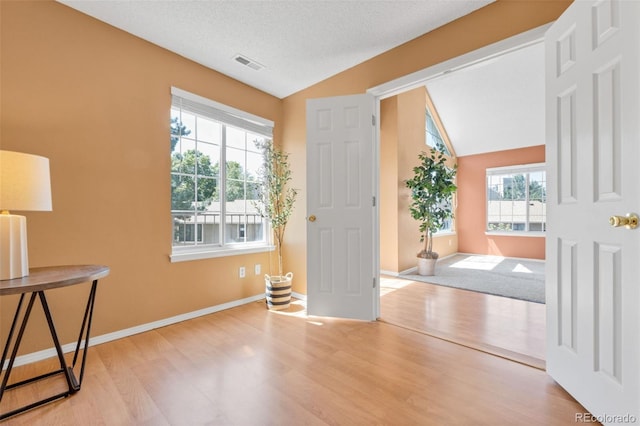 13782 E Lehigh Ave Unit H, Aurora, CO 80014 - entryway with wood finished floors and lofted ceiling