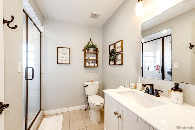 bathroom featuring toilet, tile patterned floors, a shower with shower door, and vanity