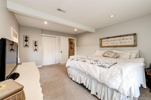 bedroom with carpet floors, a closet, and beamed ceiling