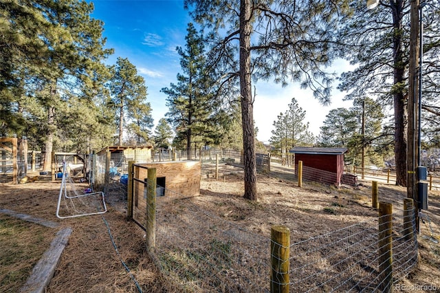 view of yard with an outdoor structure and fence