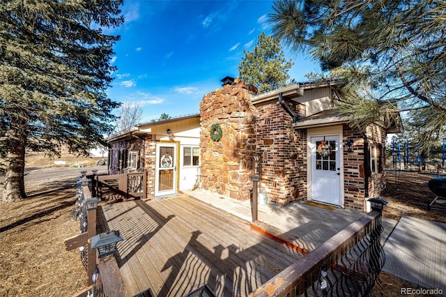 back of property featuring a wooden deck