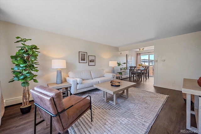 living room with a baseboard heating unit and dark hardwood / wood-style flooring