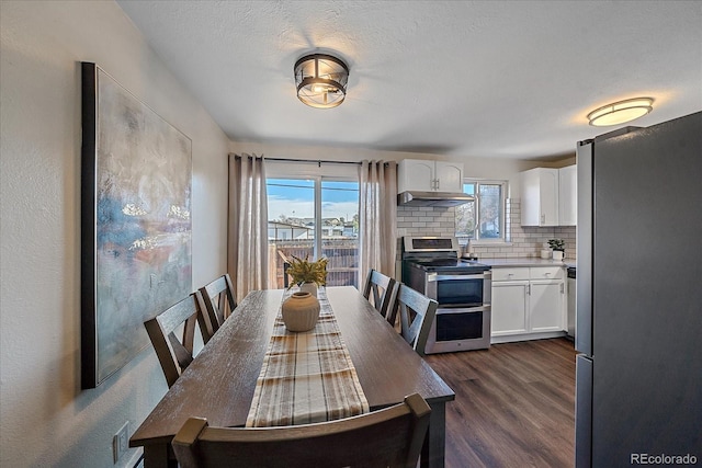 dining room with dark hardwood / wood-style flooring and a textured ceiling