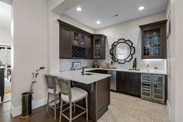 bar featuring indoor wet bar, dishwasher, tasteful backsplash, and wine cooler
