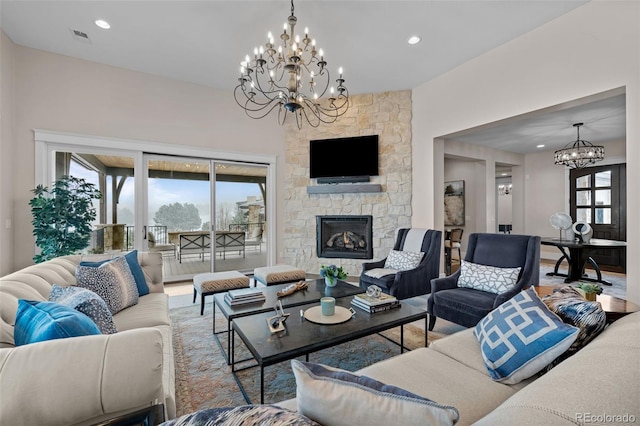 living room with visible vents, wood finished floors, a fireplace, recessed lighting, and a chandelier