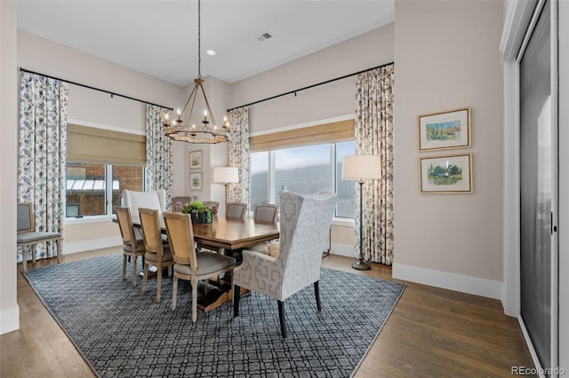 dining room featuring baseboards, an inviting chandelier, a healthy amount of sunlight, and visible vents