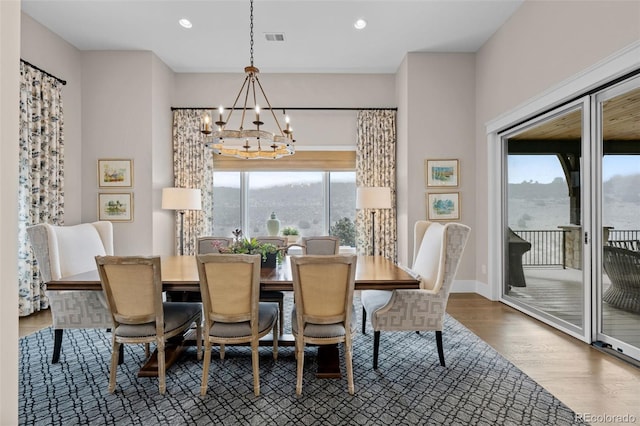 dining area featuring an inviting chandelier, recessed lighting, wood finished floors, and visible vents