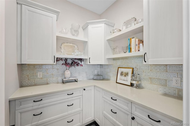 kitchen with open shelves, decorative backsplash, white cabinets, and light countertops
