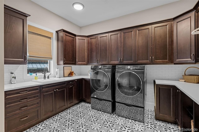 washroom featuring a sink, cabinet space, independent washer and dryer, and light tile patterned floors