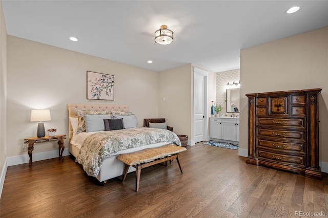 bedroom featuring connected bathroom, recessed lighting, baseboards, and wood finished floors